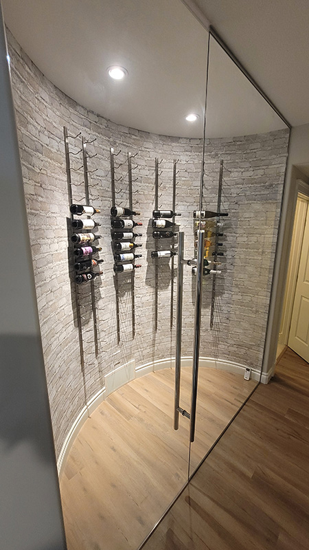 Custom wine celler built into the dead space under teh stairs creates a stunning aesthetic.