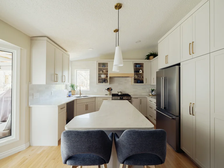 Detail of gas range, glass-front display cabinet, and natural maple hood valance — kitchen renovation in Spruce Grove, AB